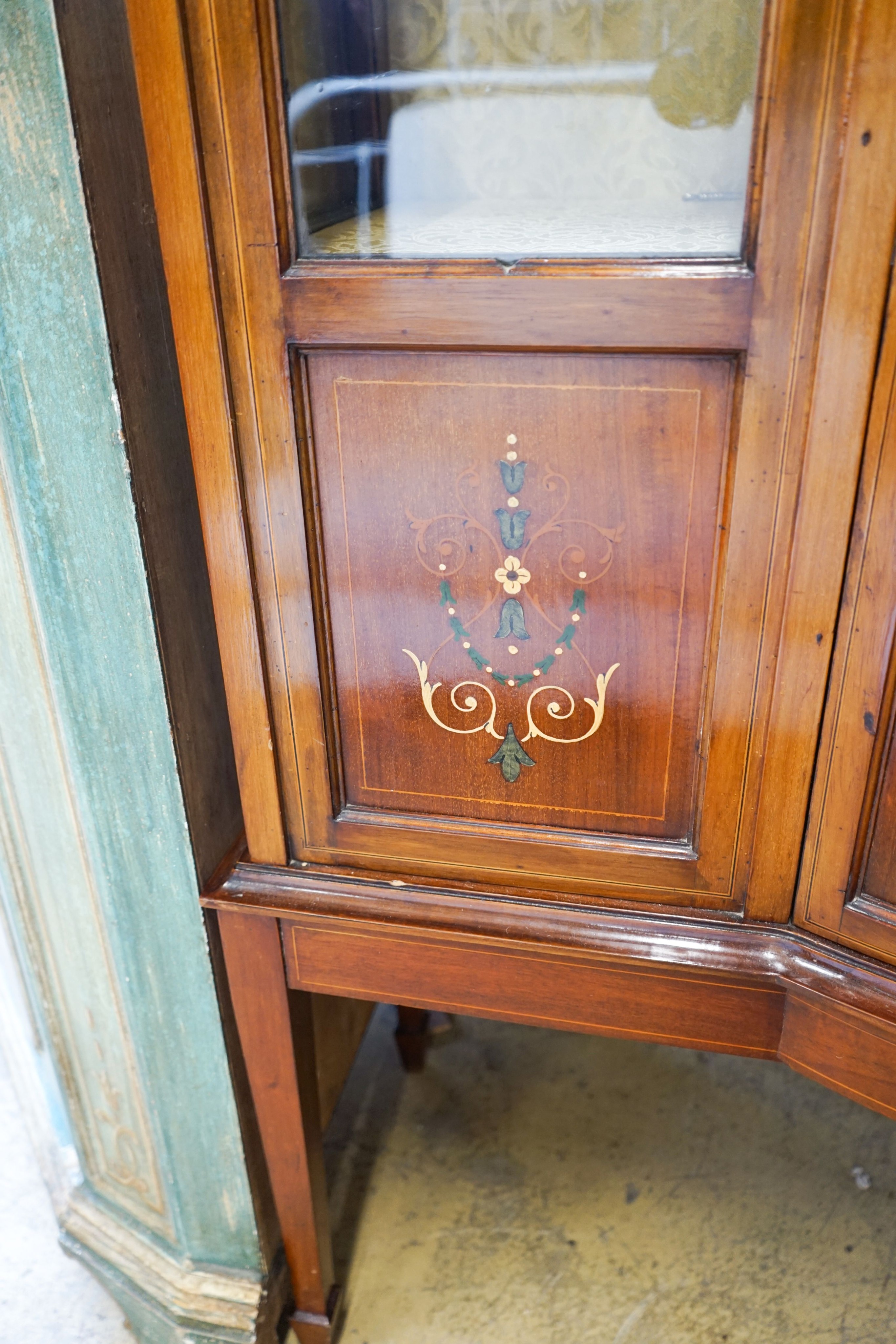 An Edwardian inlaid mahogany bow front display cabinet, width 115cm, depth 43cm, height 178cm